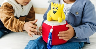 two toddlers playing with a storypod