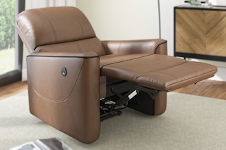 Lifestyle image of a brown Hillsdale Faux Leather Recliner Chair in living room setting