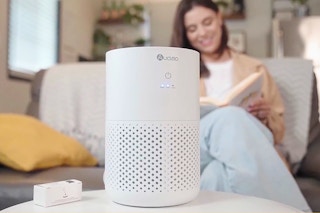 air purifier on a table with a person in the background