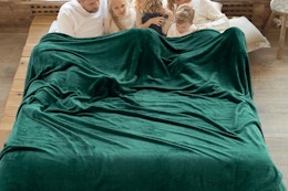 an oversized fleece blanket on a bed