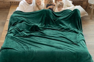 an oversized fleece blanket on a bed