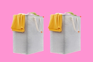 Two grey and white striped laundry baskets with 80 L capacity each stand next to each other with laundry hanging over their edges.