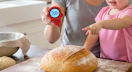 a person using a thermometer in a loaf of bread