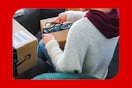a woman opening an amazon box
