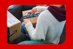 a woman opening up an amazon box