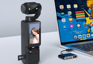 a vlogging camera next to a laptop