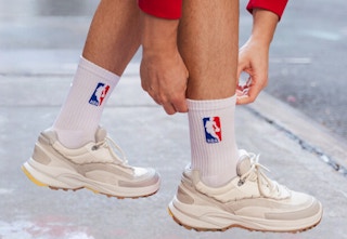 person pulling up NBA socks that they are wearing