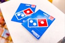 2 dominos gift cards on a shelf