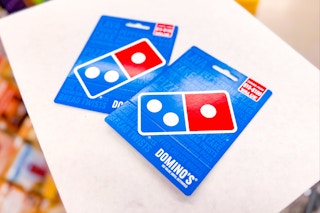 2 dominos gift cards on a shelf