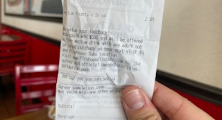 A person holding a Firehouse Subs receipt.