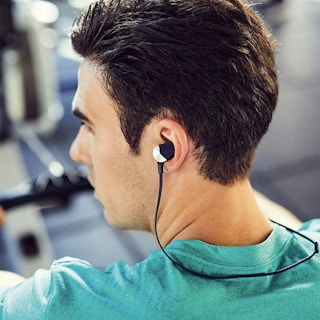guy wearing Fitbit Flyer Around-the-Neck Fitness Earbuds