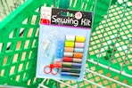 sewing kit sitting in green dollar tree shopping cart