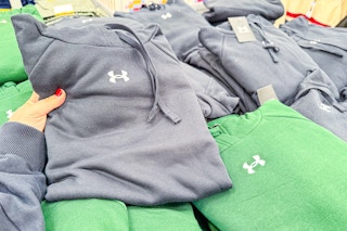 hand holding an under armour hoodie
