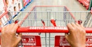 A Costco shopping cart being pushed down an aisle