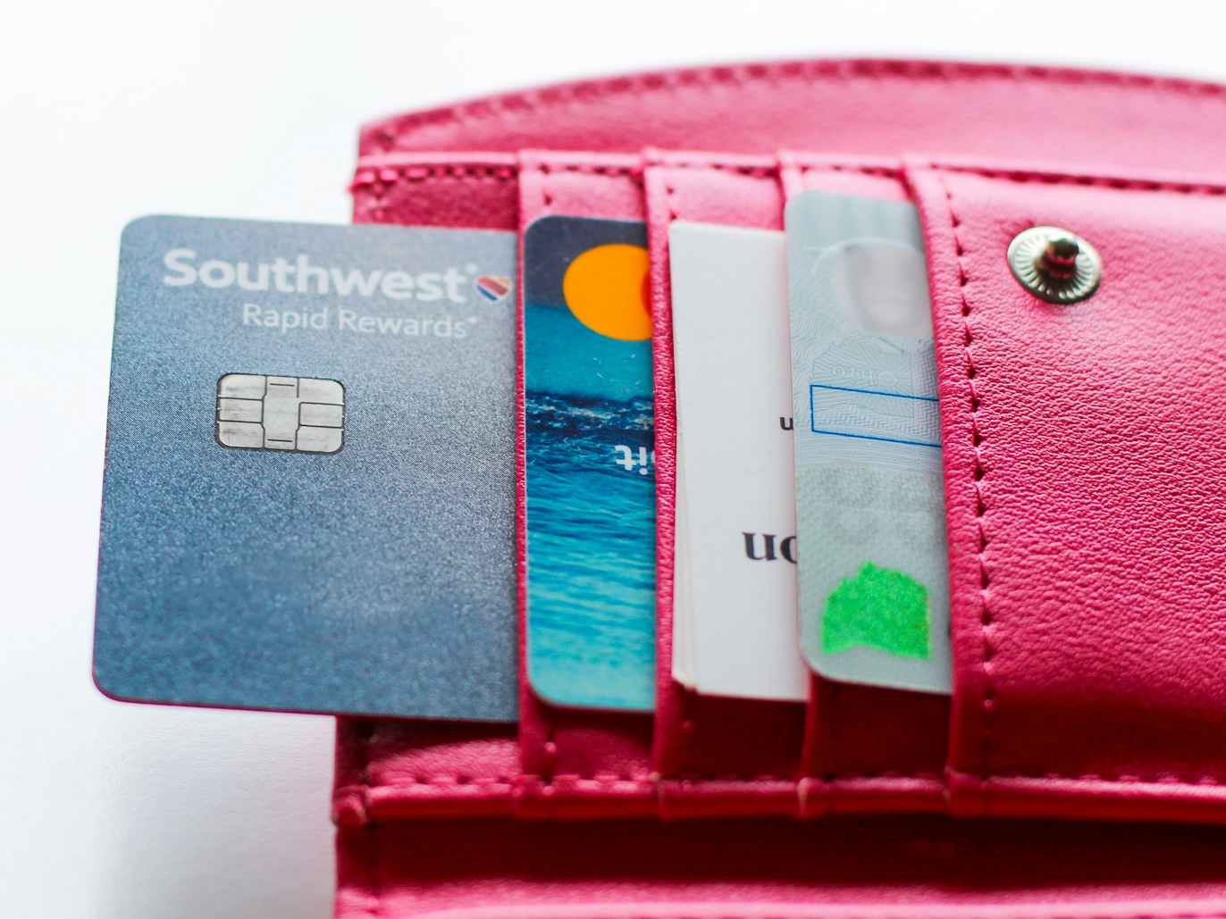 a wallet full credit cards with the southwest rapid rewards card being in focus