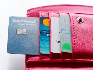 a wallet full credit cards with the southwest rapid rewards card being in focus