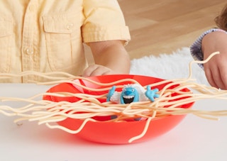 kids playing a game with toy spaghetti