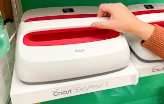 a hand on a Cricut EasyPress 2 machine