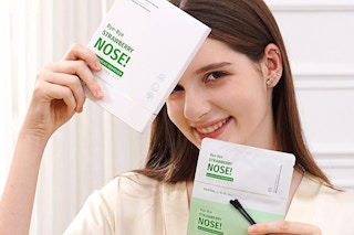 a woman holding up zealsea pore strips