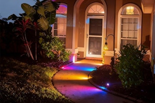 spotlights in front of house along the sidewalk