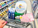hand pushing a walgreens shoping cart with P&G products