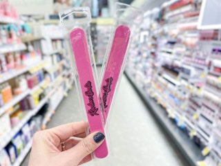 hand holding two revlon nail files