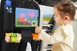 a girl playing with a peppa pig screen