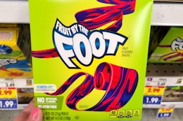 hand holding a box of general mills fruit snacks