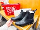 Women's boots is shoe aisle at Target with shopping basket in the background