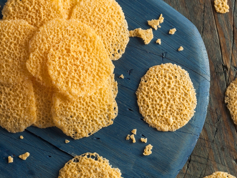 crispy triple cheddar cheese crisps on blue serving board