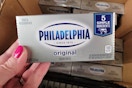hand holding philadelphia cream cheese