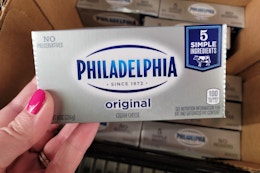 hand holding philadelphia cream cheese