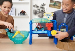 children playing with the monster truck wash
