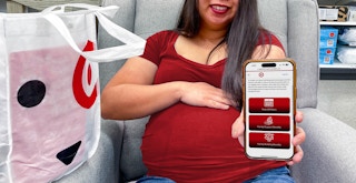 A pregnant person holding up a phone displaying the Family benefits on the Target employee website