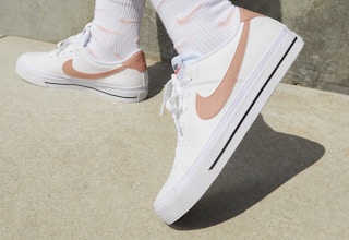 a person wearing nike court legacy shoes