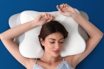 Woman sleeping on the MOLBOX Cervical Neck Pillow.