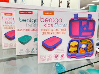Two Bentgo Kids Brights lunch boxes and a Bentgo Fresh lunchbox sitting on a shelf at Kohl's.