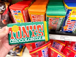 Holding a Tony's Chocoloney chocolate bar 