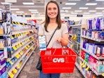 woman holding iphone and cvs shopping basket