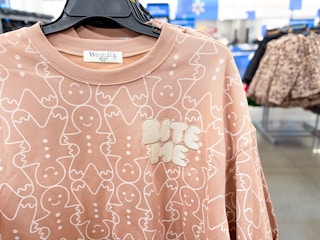Close up shot taken in stores at Walmart of the "Bite Me" Gingerbread Man women's sweater