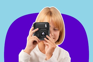 child holding a black instant camera