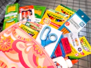 school supplies sitting in a backpack in a walmart cart