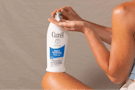 a person pumping lotion on their hands from a bottle