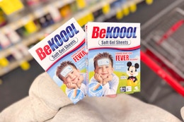 person holding 2 boxes of be koool fever cooling sheets