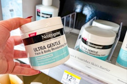 person holding a neutrogena moisturizer jar