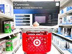 kenmore microwave oven sitting on top a target cart
