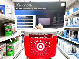 kenmore microwave oven sitting on top a target cart