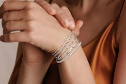 close up of a woman's wrist wearing bracelets