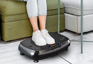 person with their feet on a vibration plate
