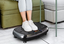 person with their feet on a vibration plate